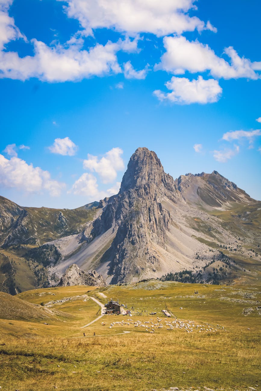 Stunning landscape of Chiappera, Piedmont, with rocky peaks under a blue sky.